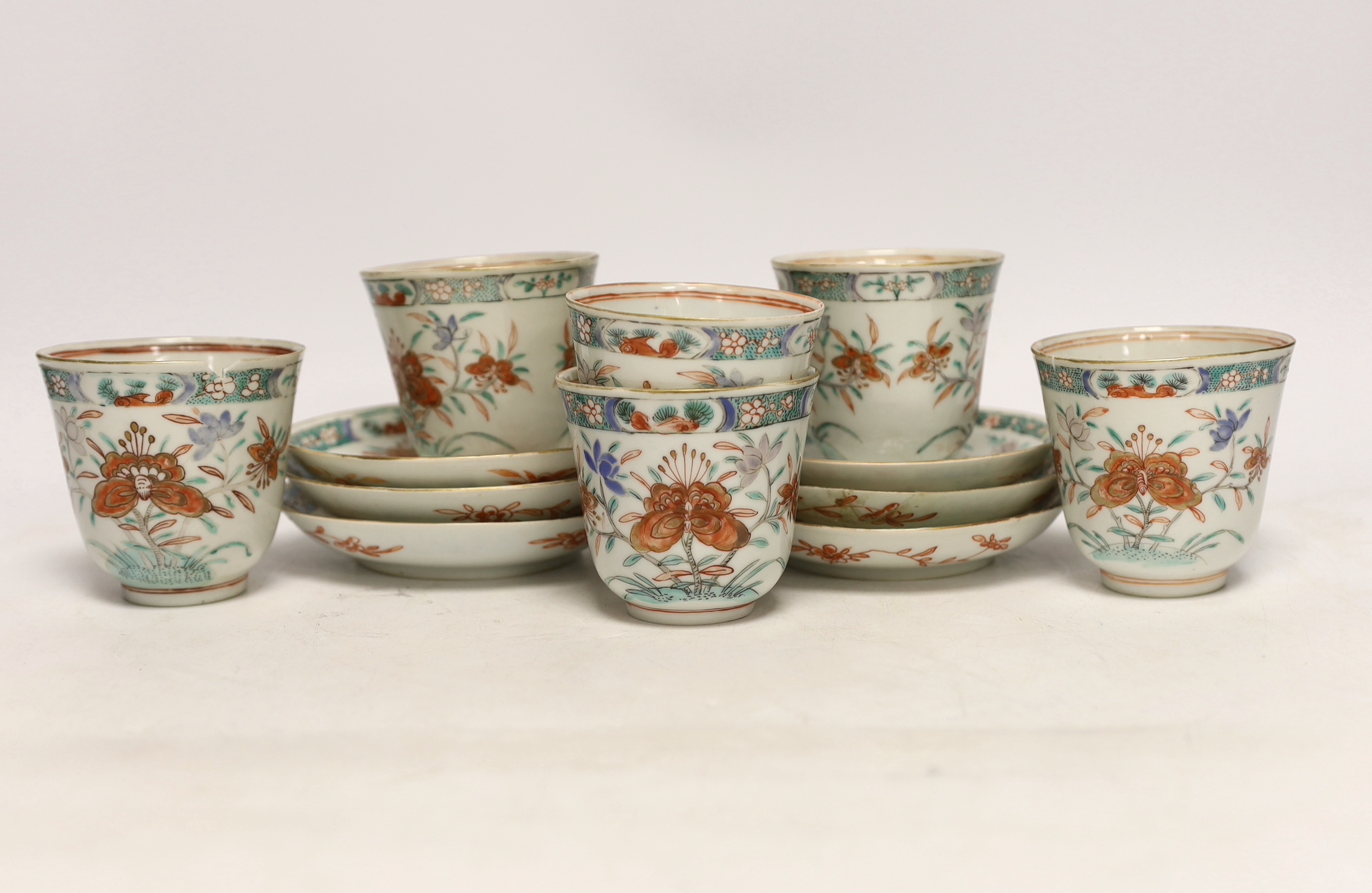A set of six early 18th century Chinese cups and saucers with Dutch enamelled decoration, c.1710, 7.5cm high